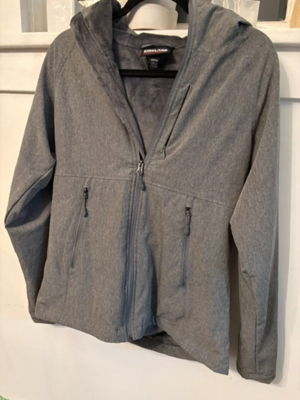 Kirkland Signature gray heather softshell jacket with zippered hood.